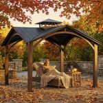 Large backyard gazebo with two-tier gable roof and integrated gutter system.